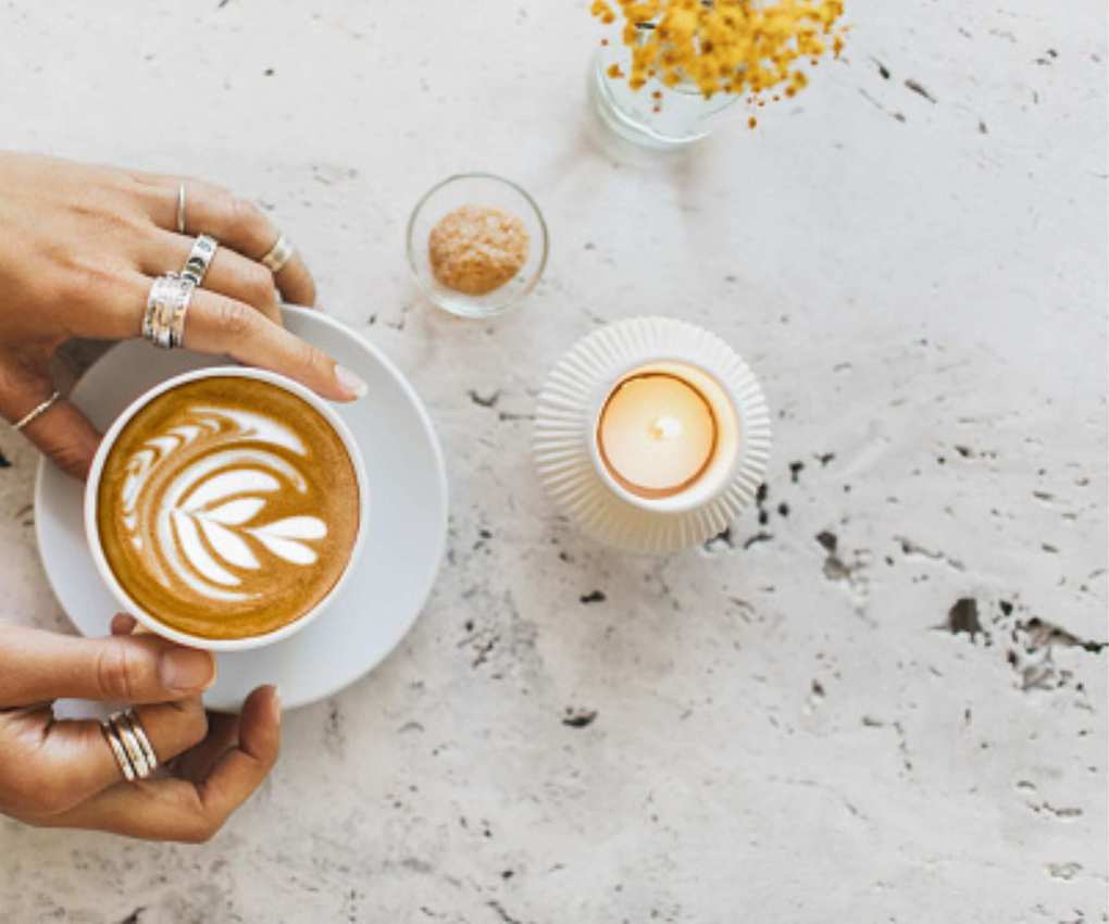 A candle and cup of coffee