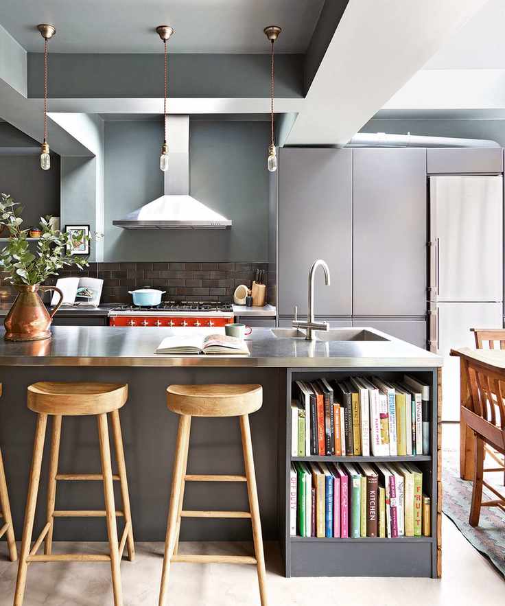 kitchen island with steel countertop and bookshelves