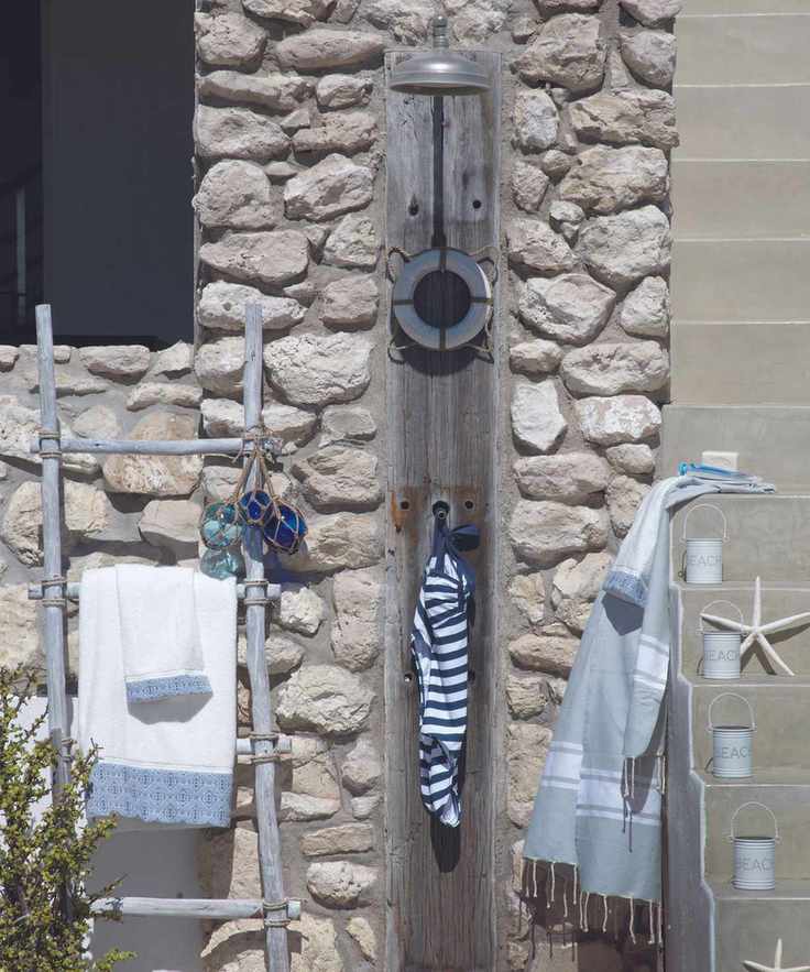 Outdoor shower on stone beach house