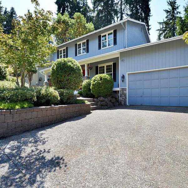Concrete driveway with blue garage door