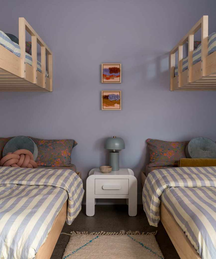 lilac children's bedroom with bunk beds with striped bedding and lots of pattern play