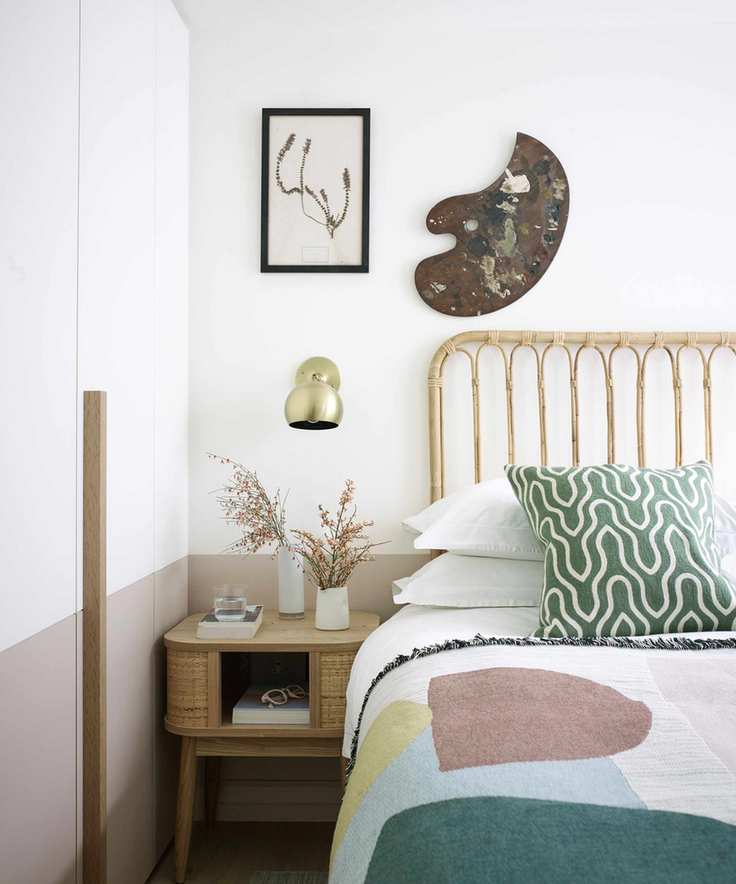 Bright white bedroom with various art styles