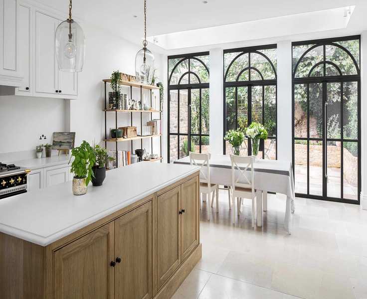 Limestone flooring in a white kitchen with crittal windows