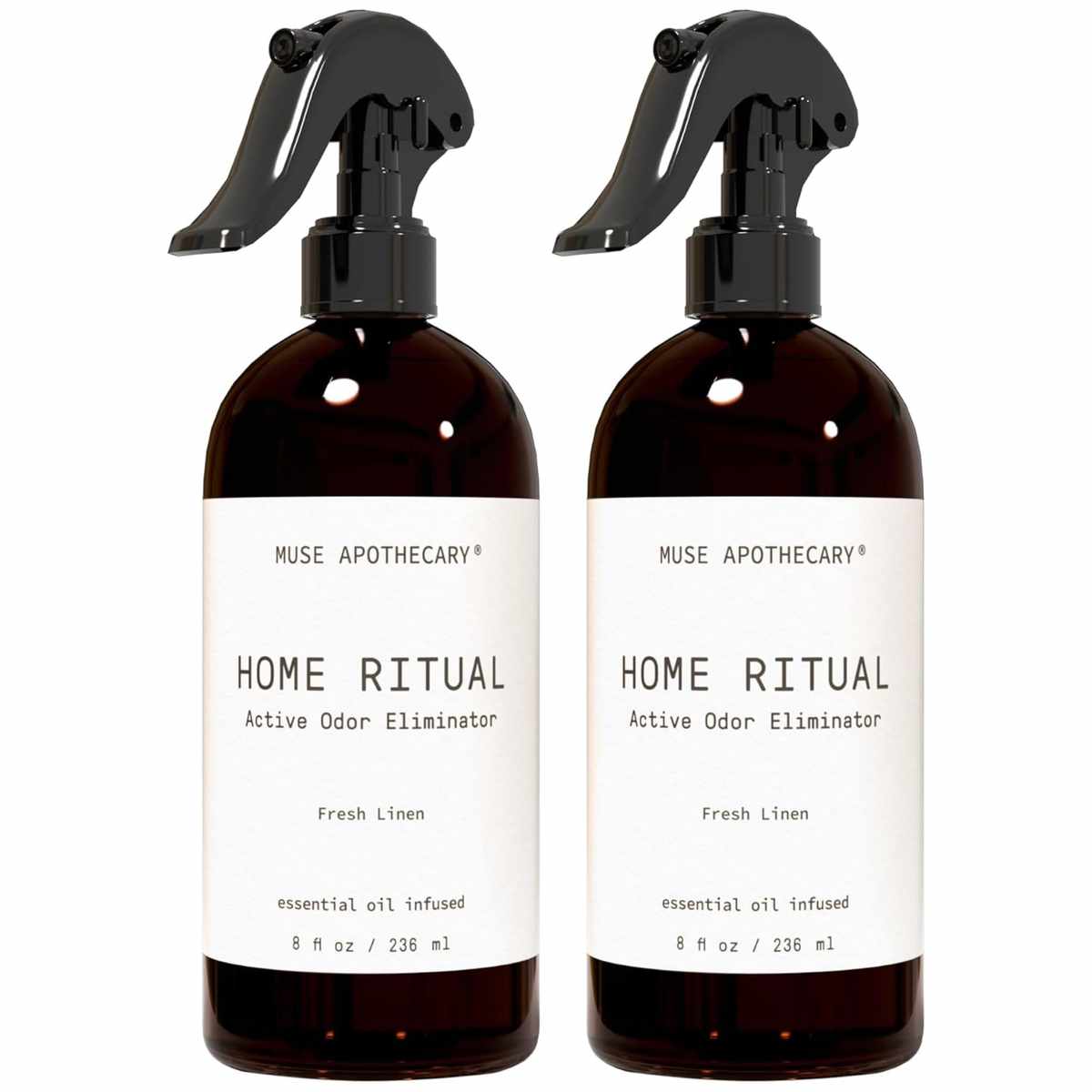 Two brown bottles of Muse Apothecary Home Ritual Active Odor Eliminator with white label with black text, and black spray lids