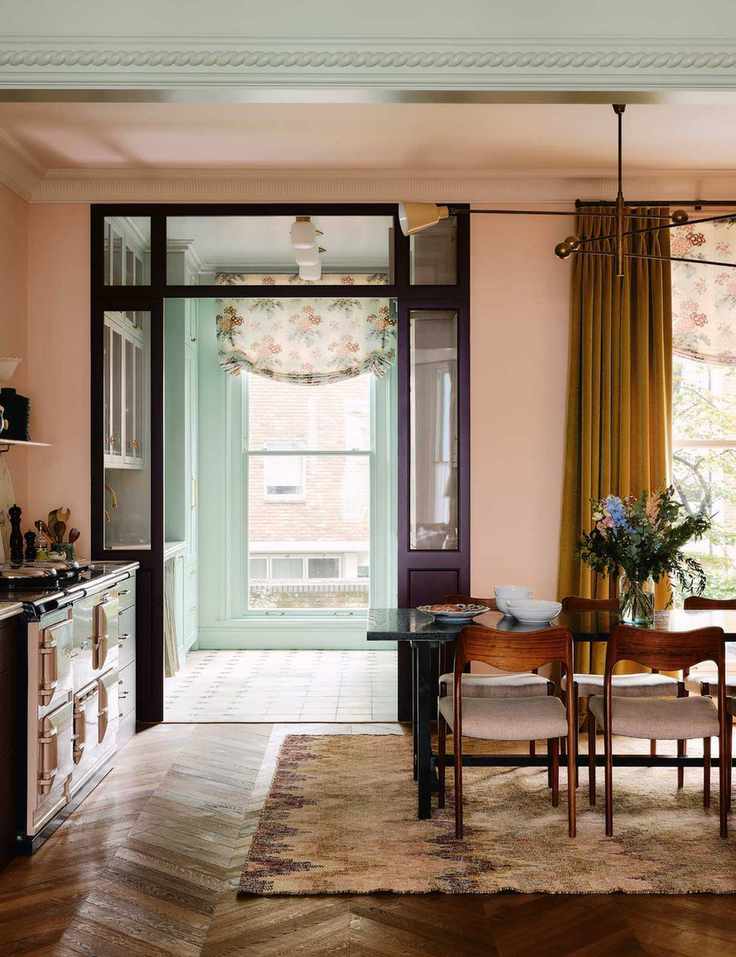 Open concept kitchen area featuring mid-century dining furniture