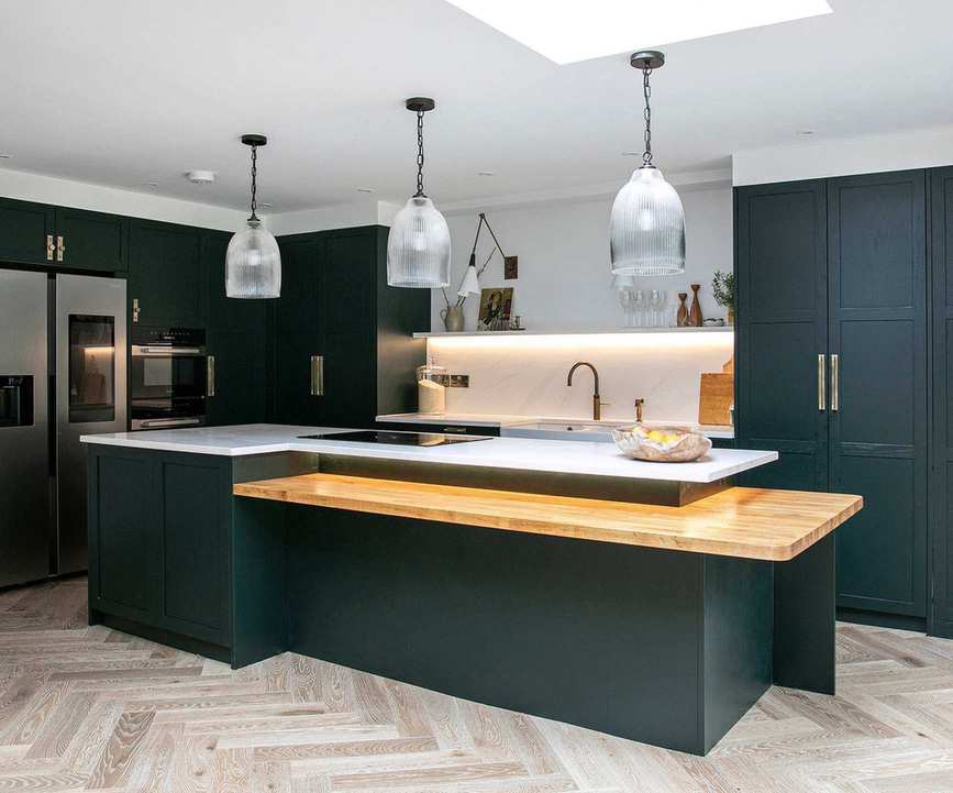 Three glass kitchen pendant lights over a kitchen island