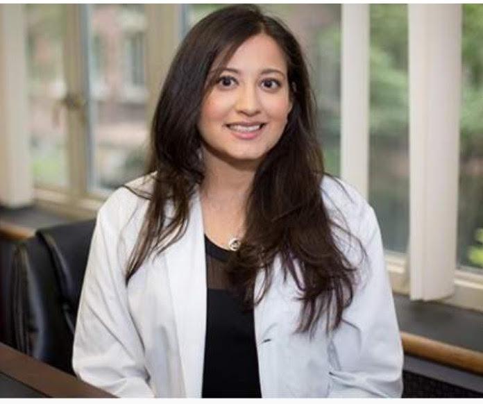 Dr. Purvi Parikh is an adult and pediatric allergist and immunologist with Allergy & Asthma Network and is wearing a white lab coat and has dark brown hair