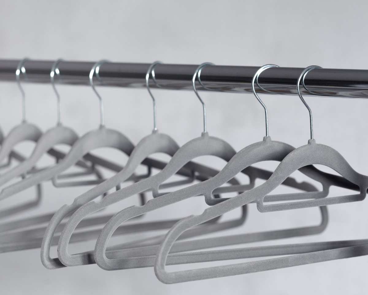 Gray velvet hangers on a rail