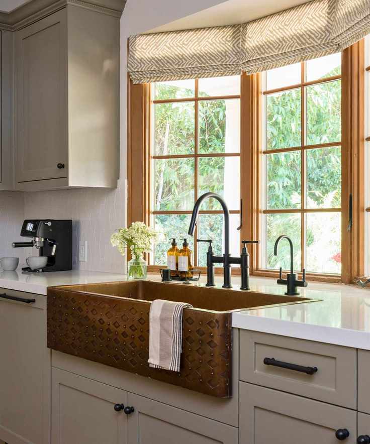 brass kitchen sink in window