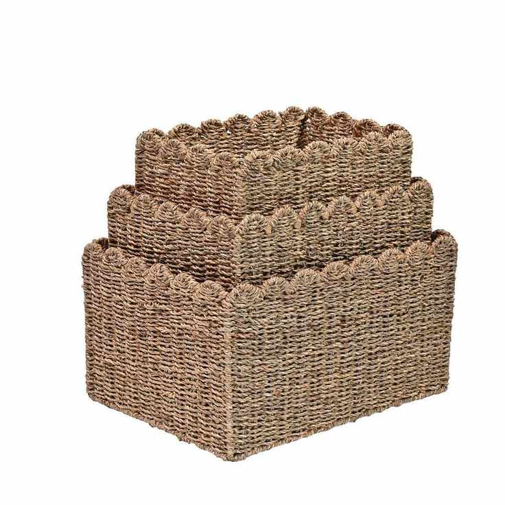 Three seagrass rectangular baskets with scalloped top border, nested inside each other on a white background