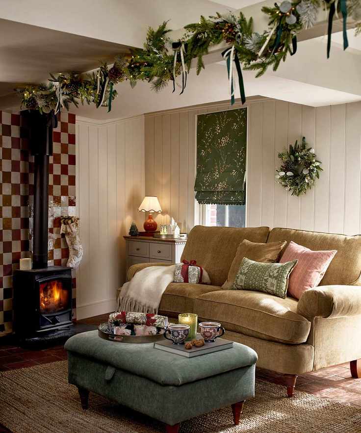 cozy living room with log burner and Christmas garland attached to ceiling beam