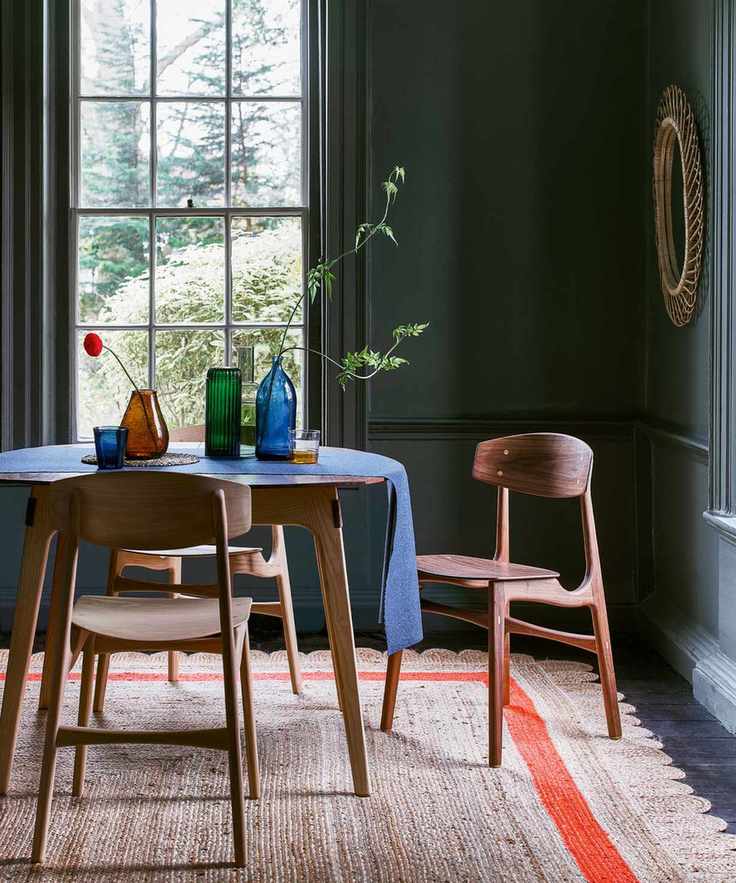 Dining room with dark blue walls and stylish decor