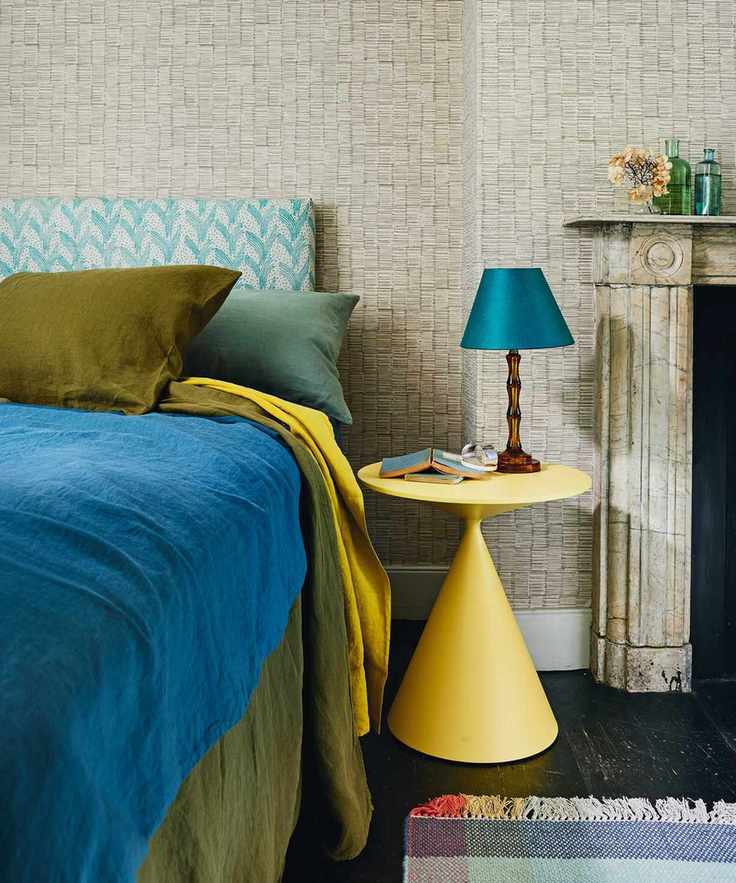 bed with side table and wallpaper