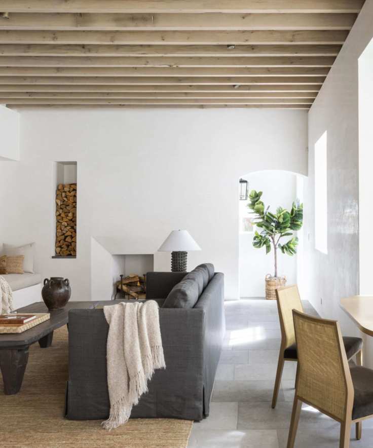 white living room with wood ceiling beams