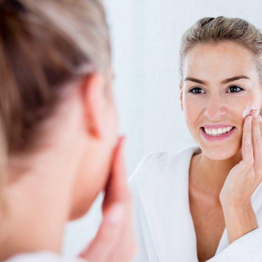 Woman using moisturizer