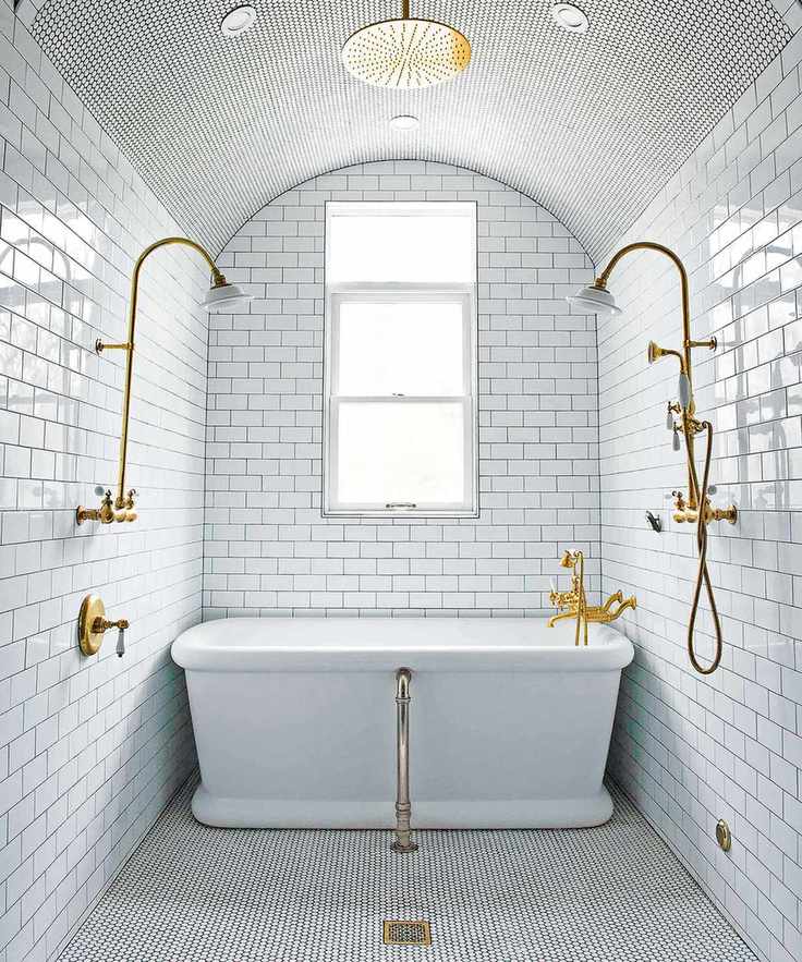 Small bathroom with white metro tiles, bath and rainwater shower