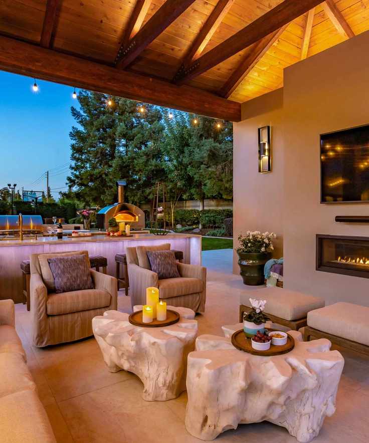 Outdoor covered living area with low tables, candles and soft seating