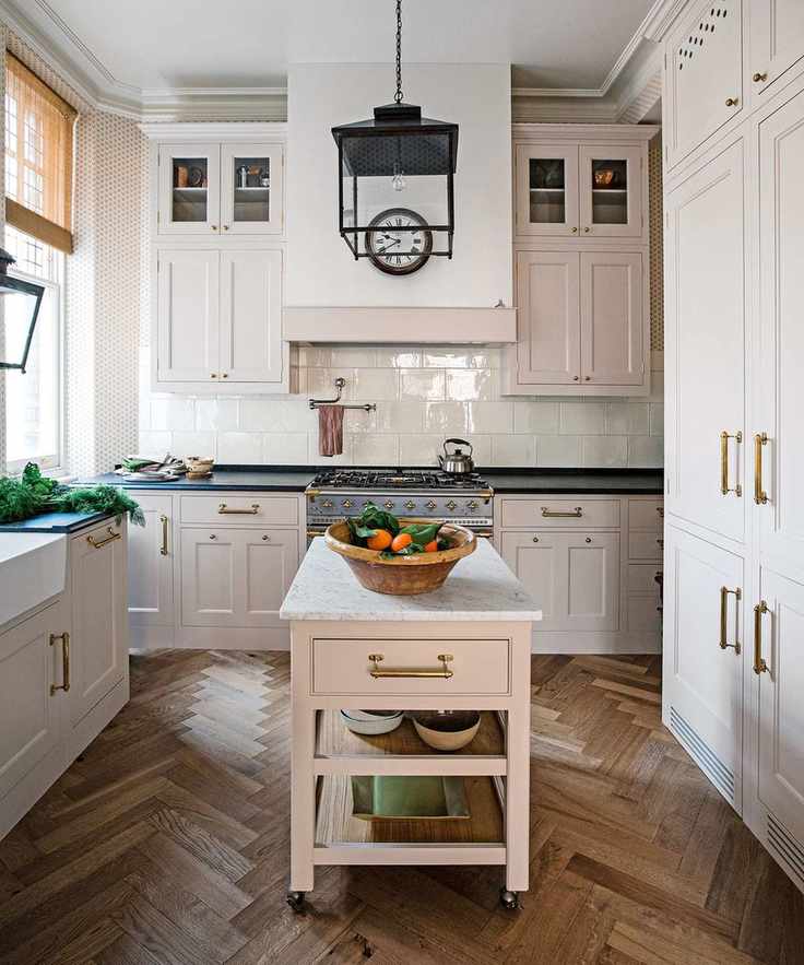 French country kitchen with cream cabinets and wood flooring
