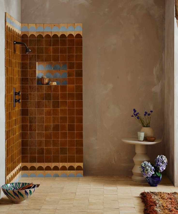 A shower room with plaster walls, Mediterranean style shower tiles, and a neutral tiled floor