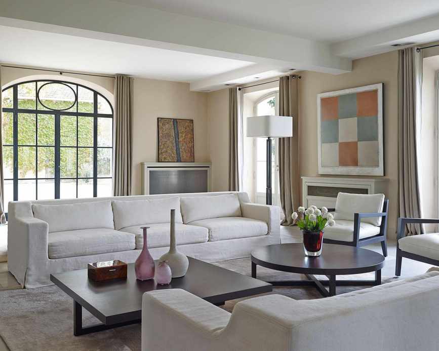 Living room with white sofas and cream walls