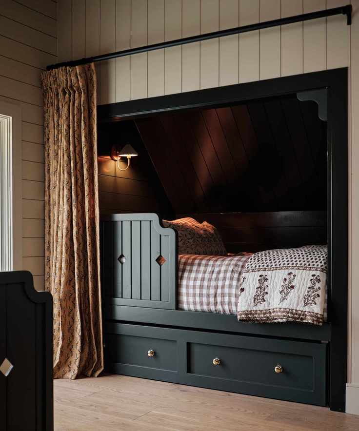 Bedroom with dark blue built-in bed nook and gingham bedding