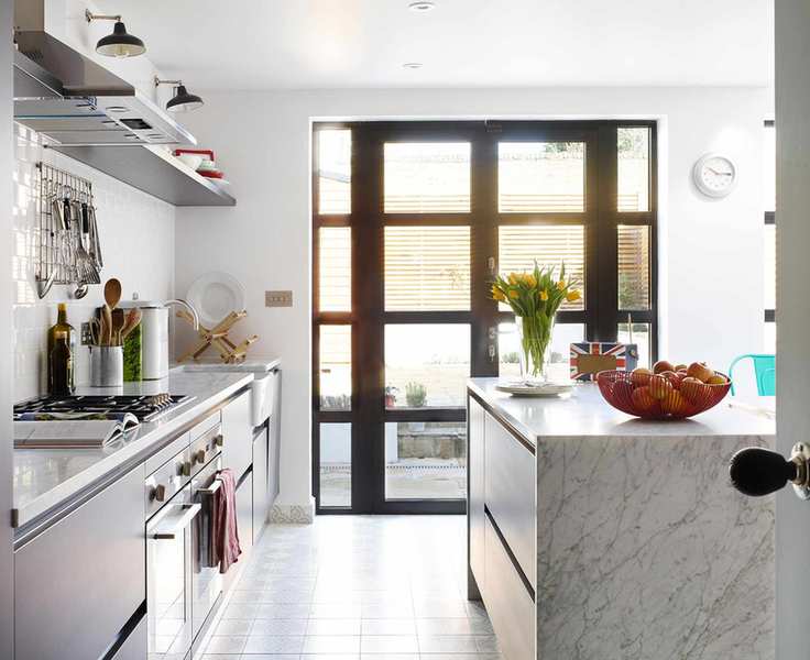 White walls and accent lamps illustrating kitchen wall lighting ideas.