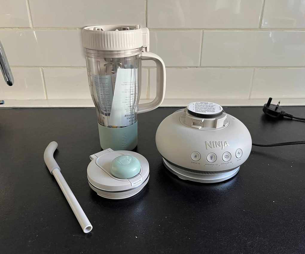 All parts of a grey Ninja BlendBoss on a black counter.