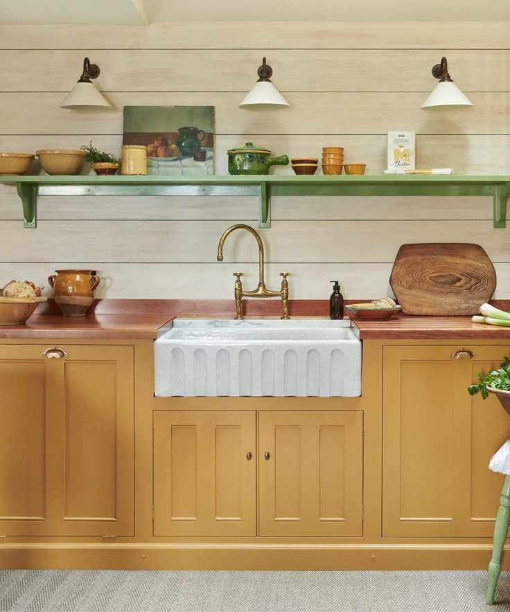 yellow kitchen with wooden countertop and fluted butler sink with vintage decor