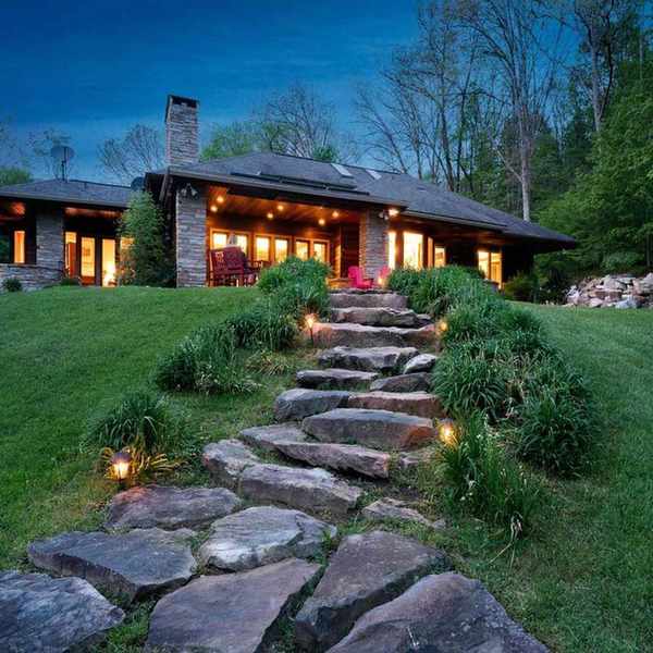 Backside exterior of a Prairie Style house illuminated at night