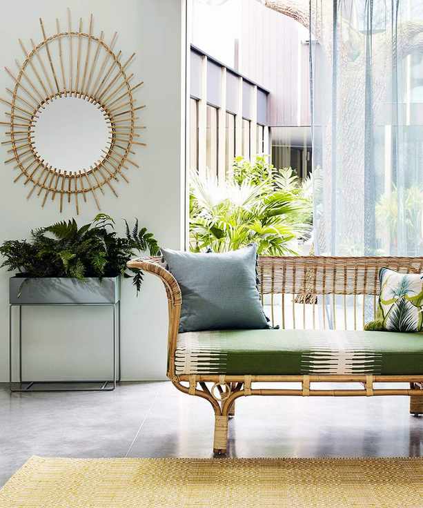 A tropical green living room picture with rattan furniture.