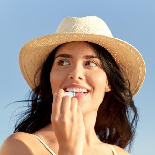 Image of model applying lip care