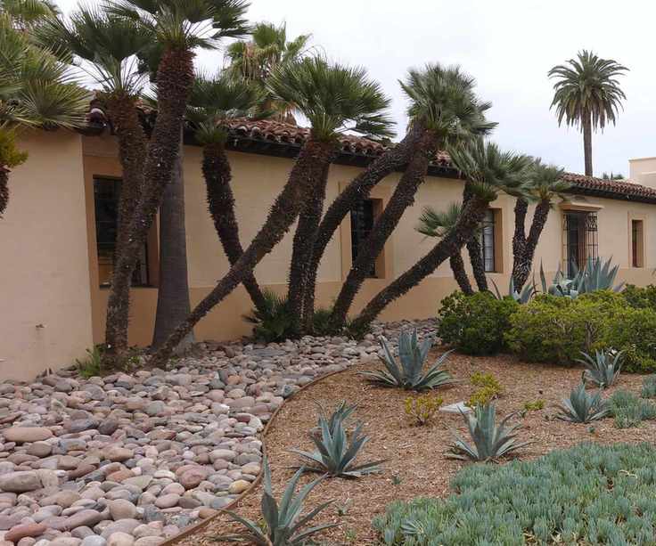 front yard with river rock landscaping and trees