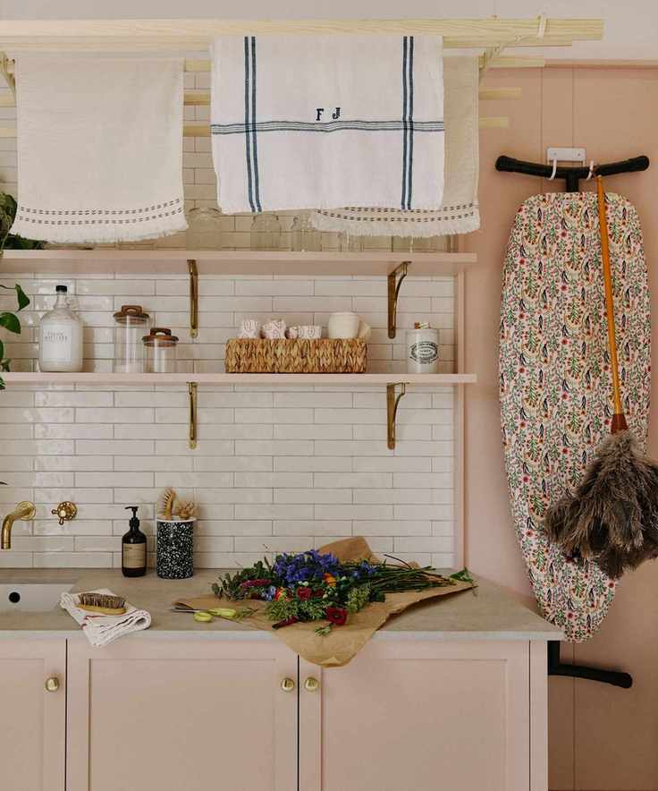 pink small utility room with sink and shelves and tiled splashback
