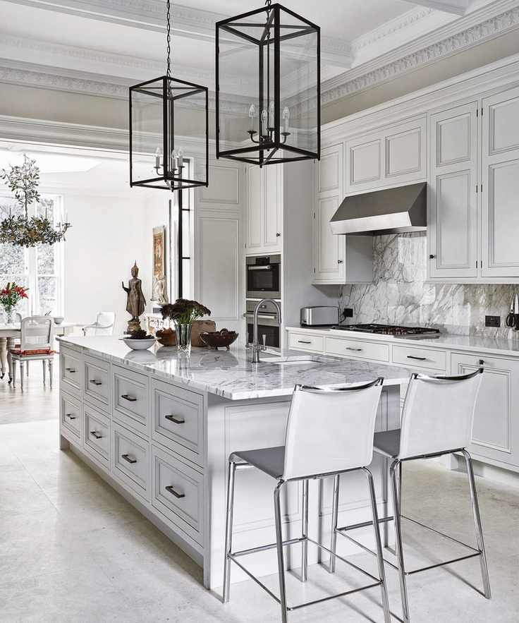 Chic white kitchen with marble-topped island