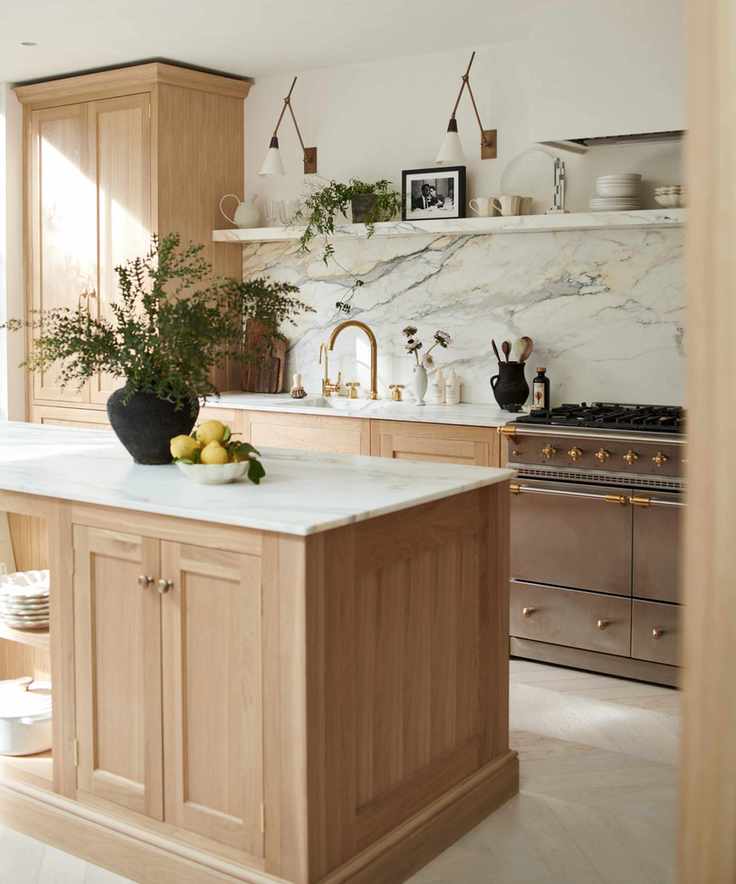 pale wood kitchen cabinetry, marble countertops and backsplash