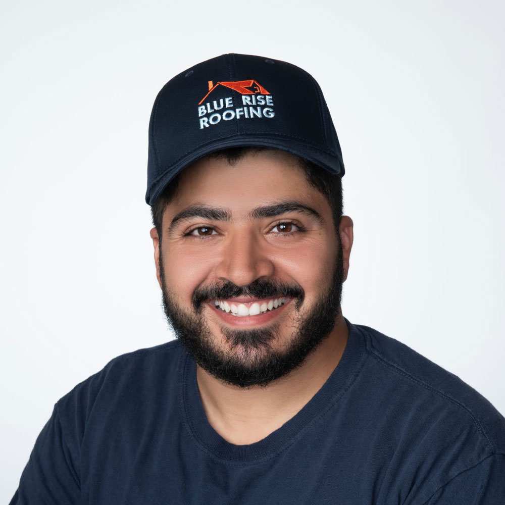 Headshot of Yaeir Moinzadeh an Asian man with facial hair wearing a blue cap