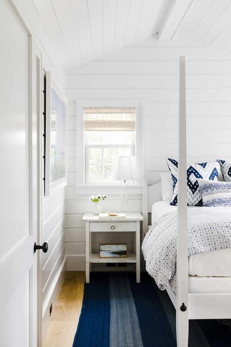 White coastal bedroom with shiplap paneling