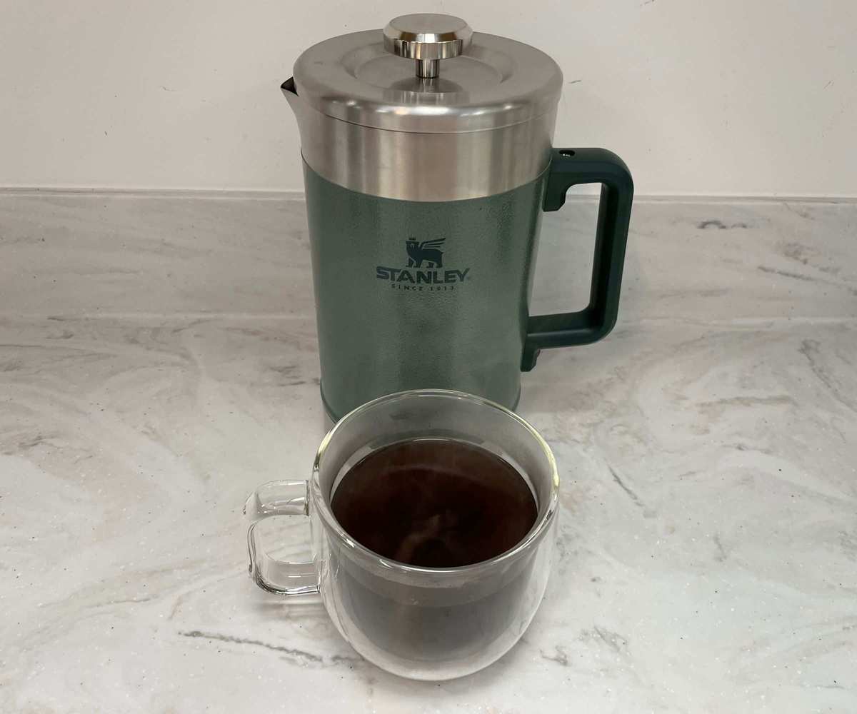 Stanley Stay Hot French Press with a cup of coffee in front of it
