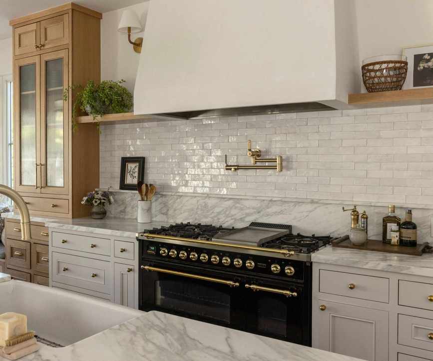 A neutral kitchen with quartzite countertops and wooden accents
