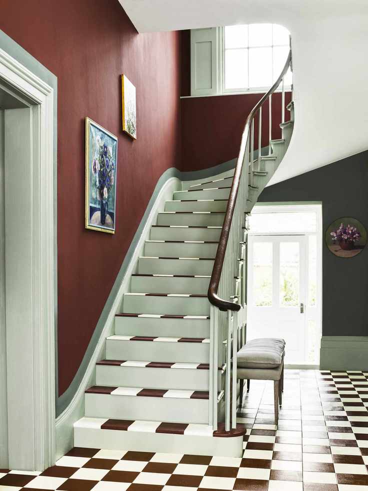 Brown and white tiled floor and stairs, red and green walls