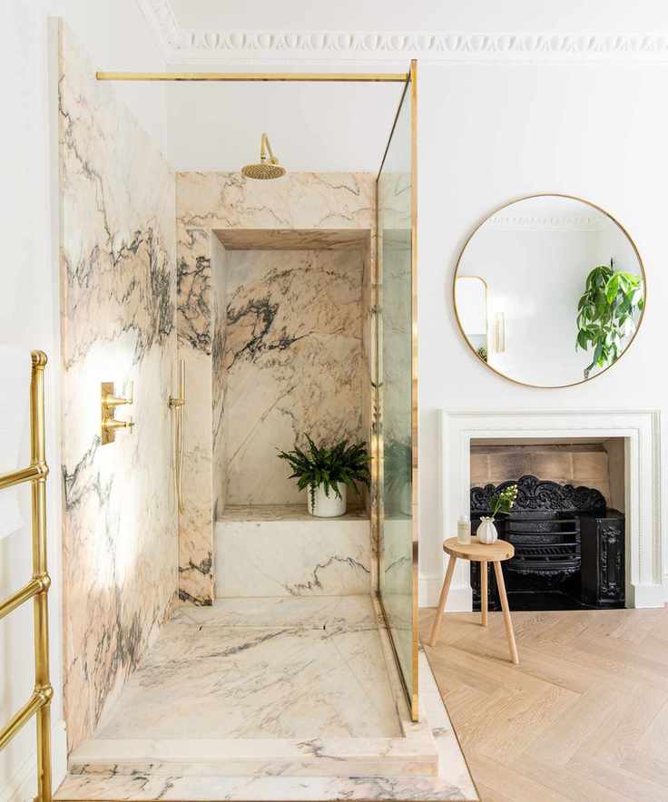 modern bathroom with large marble shower and original fireplace