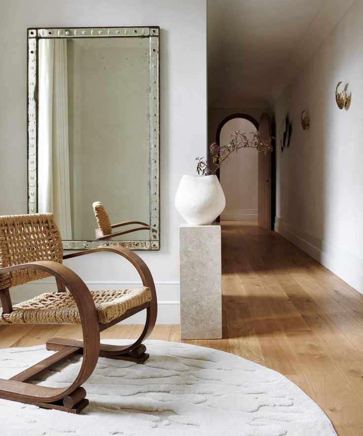 Narrow entryway with round rug
