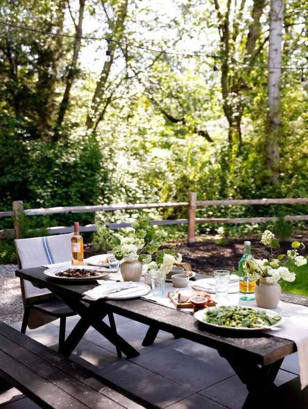 black picnic table with runner and dinner party table settings