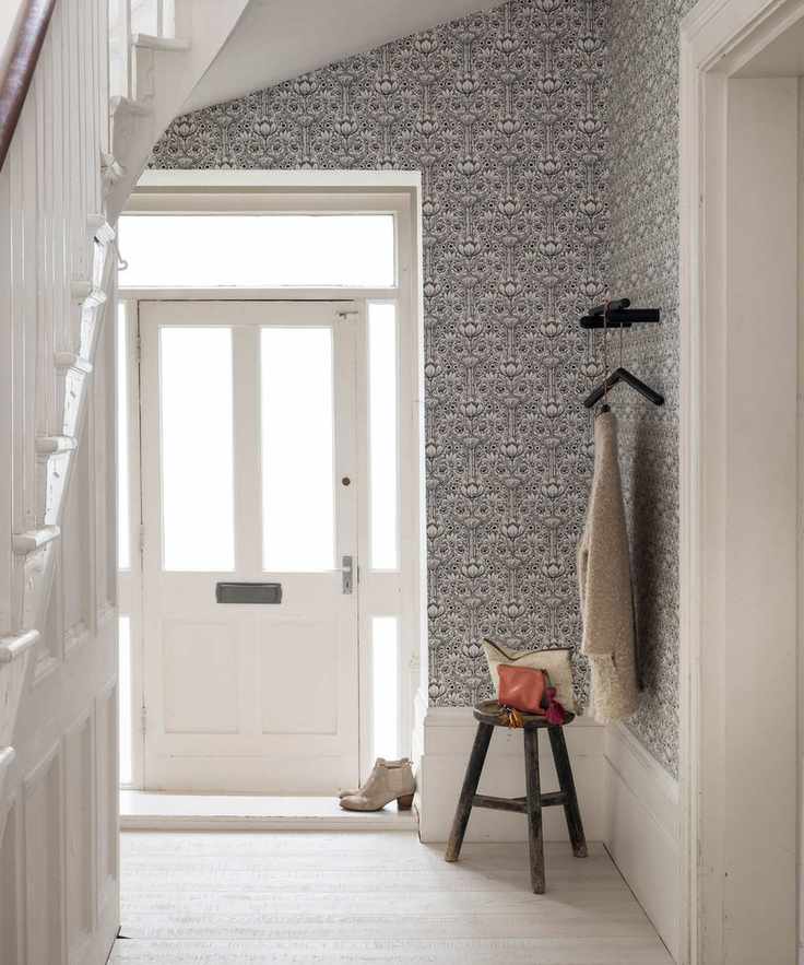 Hall, open ajar white front door, Art Nouveau floral wallpaper, all white painted walls and wooden floorboards