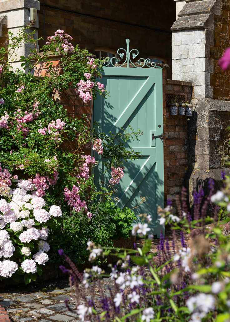 Painted timber garden gate with ornate metalwork top