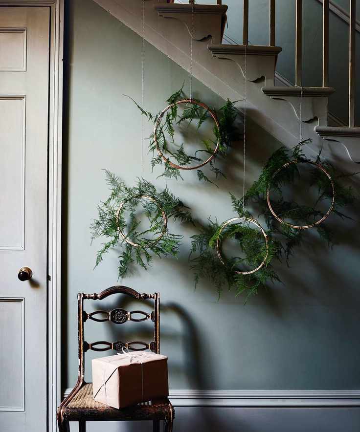 Creative Christmas wreaths in an entryway