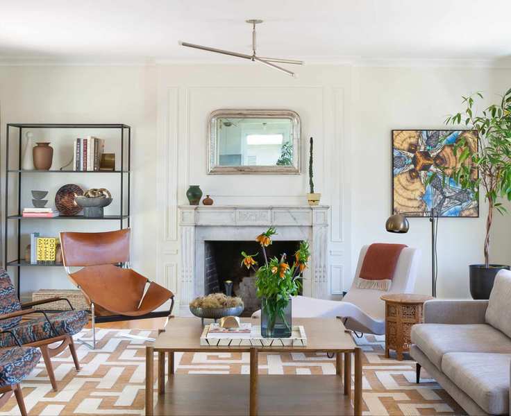 Modern living room with seating area arranged around fireplace