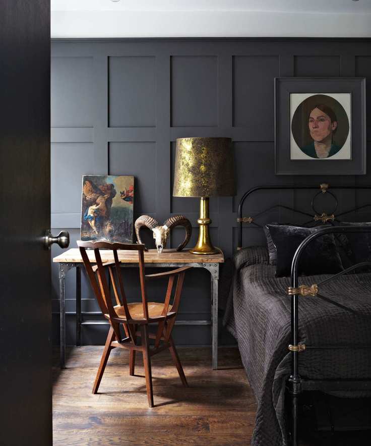Black bedroom with iron headboard painted in Farrow & Ball railings