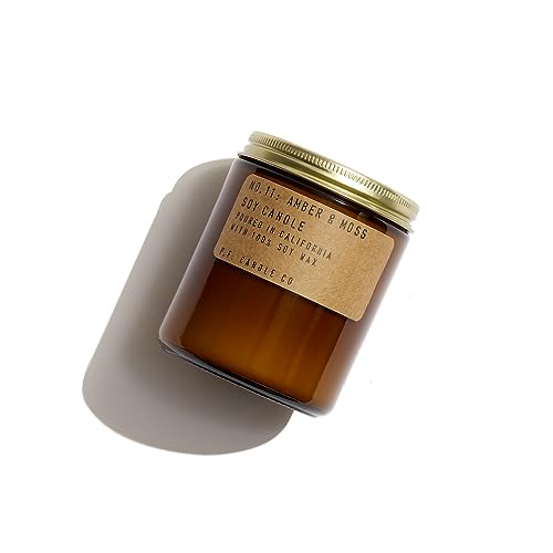 An amber glass jar with a brown paper label and gold screw on lid