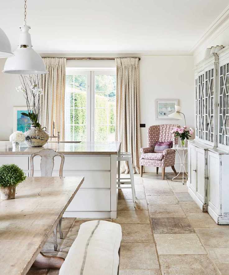 Spacious kitchen diner with large reclaimed dresser and wooden table and benches and kitchen island.